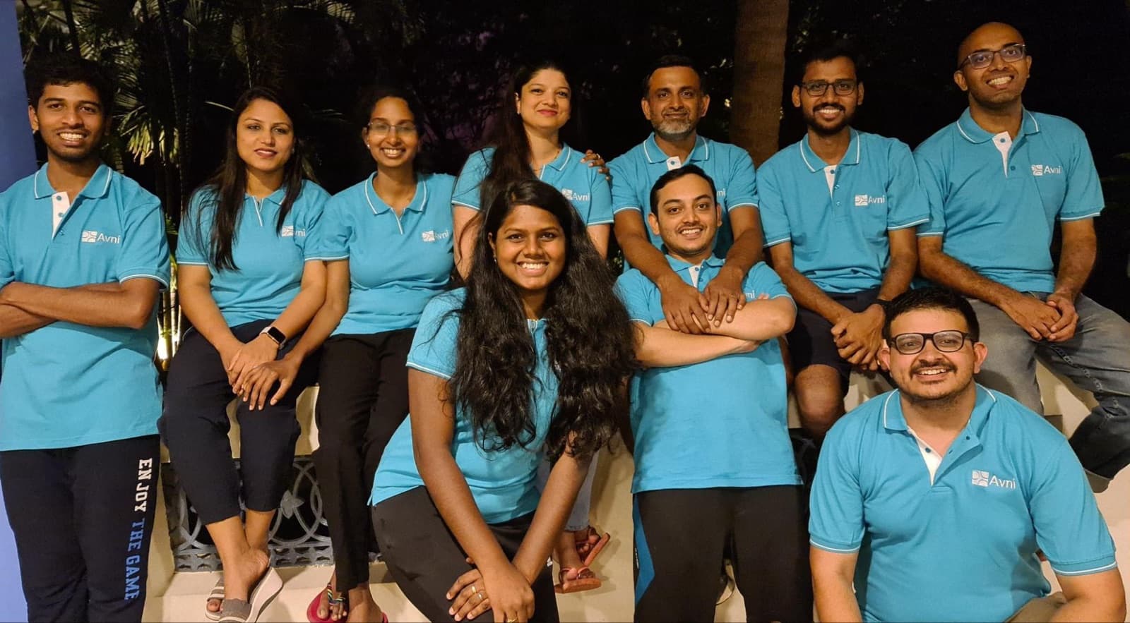 The Avni team, in matching Avni t-shirts, photographed together in the evening